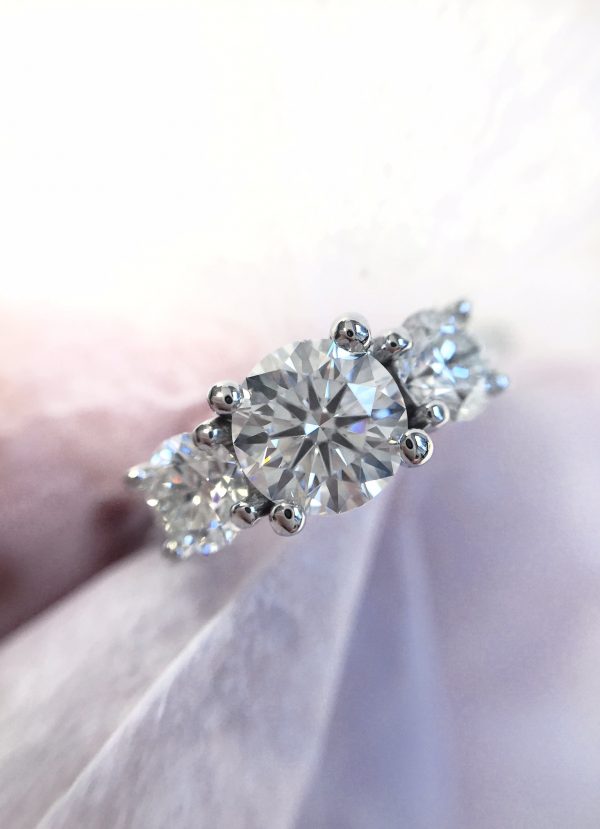 round diamond trilogy engagement ring